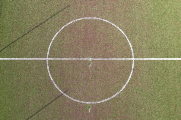 Aerial view ao a soccer field in a pubblic park inside a town