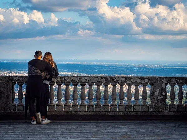 Couple of lovers on the balcony of Sacro Monte in Varese ( the plate on the railing says that Pope Vojtyla blesses the Po Valley during his visit on that balcony)