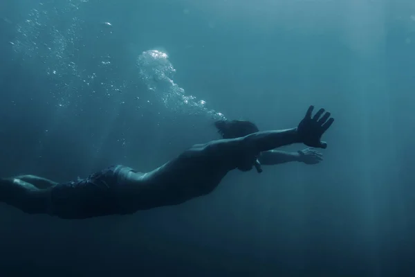 Young man swimming underwater, breaststroke. — Stock Photo, Image