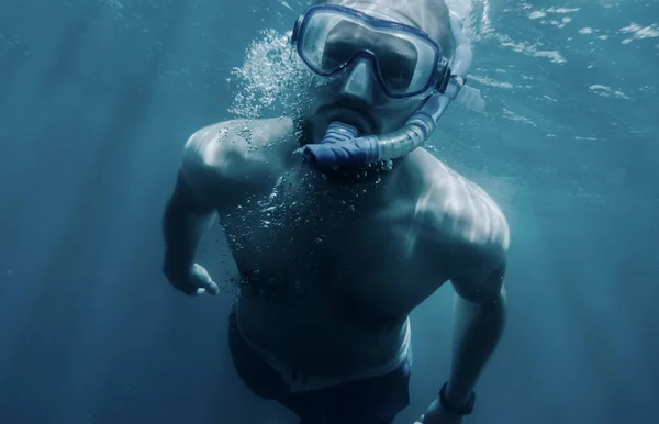 Active man swimming underwater. — Stock Photo, Image