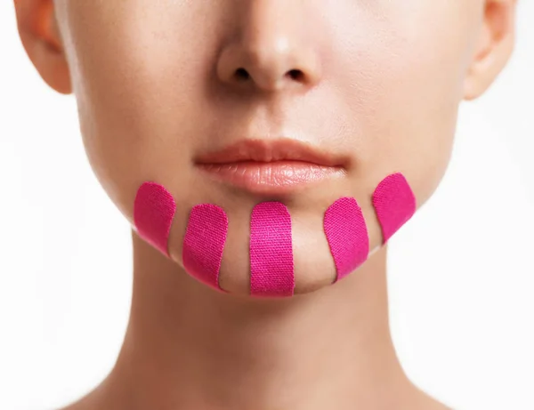 Woman with kinesio tapes on chin, beauty procedure. — Stock Photo, Image