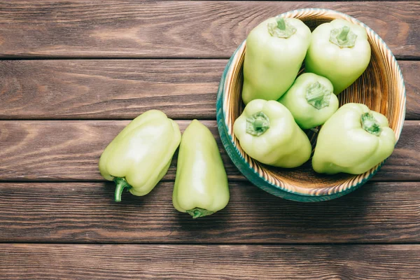 Fresh green peppers on wooden table. — Stock Photo, Image