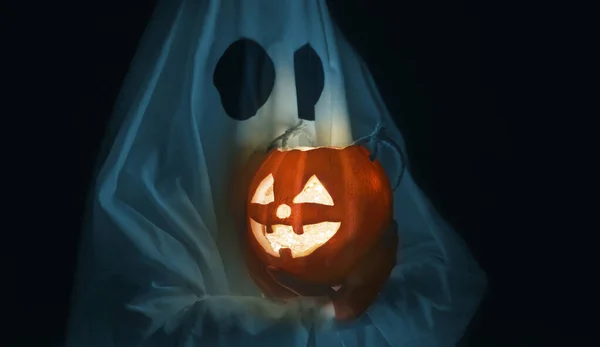 Halloween ghost holding glowing jack-o-lantern. — Stock Photo, Image
