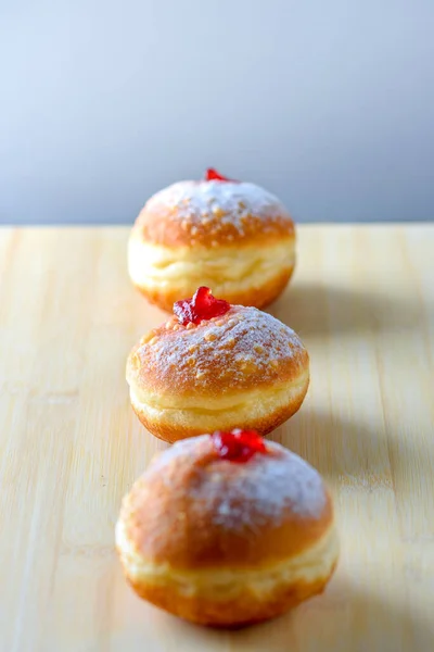 Close up view of tasty Jelly Doughnuts with jam on wood background. Hanukkah celebration concept. — Stock Photo, Image
