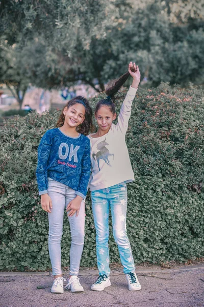 Two young happy hipster girl friends with ponytail standing together and having fun. — Stock Photo, Image