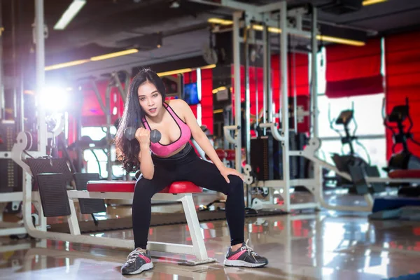 Fitness Asian women performing doing exercises training with dum — Stock Photo, Image