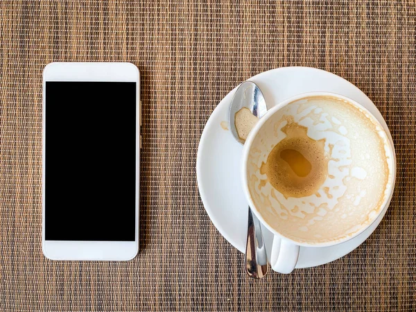 Smartphone and Empty coffee cup on wood desk on top view. — Stock Photo, Image
