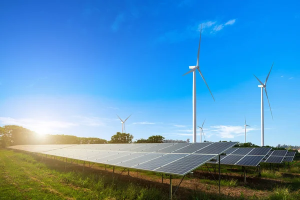 Solar panels with wind turbines against mountanis landscape agai — Stock Photo, Image