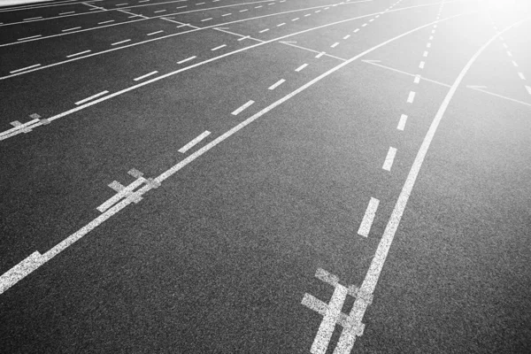 White lines of stadium and texture of running racetrack black ru