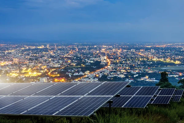 Solar panel with city night architecture electric energy light b — Stock Photo, Image