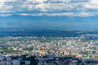 CHIANG MAI, THAILAND - 9 Haziran 2020: Beyaz bulutlu parlak mavi gökyüzü arkaplanı üzerinde şehir manzarası olan dağları görmek. Chiang Mai, Tayland 'ın
