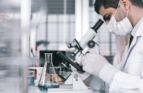 Científico Masculino Trabajando Mirando Microscopio Con Tubo Ensayo Muestra Investigador — Foto de Stock