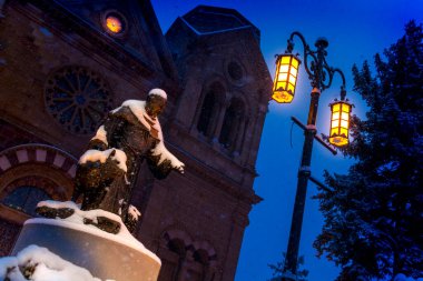 Santa Fe New Mexico 'daki St. Francis Katolik Kilisesi Katedrali' nin dışındaki Aziz Francis Heykeli 'nin kar manzarası, bölgenin mirasını ve tarihini gözler önüne sermektedir. Bu fotoğrafta kar çok şiddetli yağıyor.. 