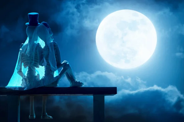 在万圣节的时候 蓝色的月亮是一对可爱的情侣的骨瘦如柴 照片生动地说明了夜晚的天空和明亮的云彩构成了一个巨大的 丰满的月亮 — 图库照片