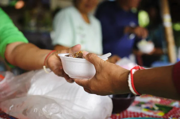 The poor have been sharing food from the kinder society to Relieve Hunger : Social concept of poor people sharing : Concept serving free food to the poor :Free food, Using leftovers to feed the hungry