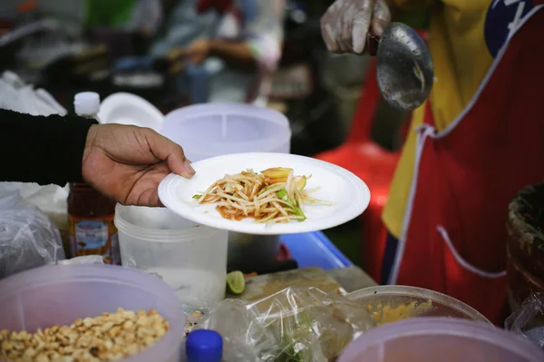 Free food for poor and homeless people donates food to food less people : The poor have been sharing food from the kinder society to Relieve Hunger : Social concept of poor people sharing