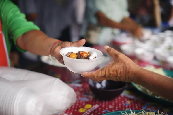 Concept serving free food to the poor : Free food, Using leftovers to feed the hungry : Food concept of hope : Food donation in the poor community of volunteers