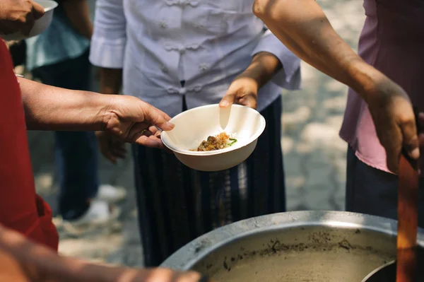 Participation in sharing food for the poor : The Concept of Love : The beggar is waiting for food from charity aid : Charity food shared to everyone in society and the poor need this charity food