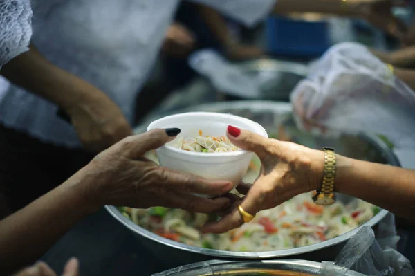 The Hope of the Poor by Donating Charity Food to the Immaculate : Participation in sharing food for the poor : The Concept of Love : The beggar is waiting for food from charity aid