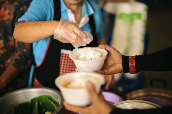 The Society of Sharing Food to Homeless and the Poorest: The Concept of Feeding : The hands of the rich give food to the hands of the poor