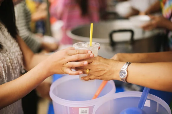 The Society of Sharing Food to Homeless and the Poorest: The Concept of Feeding : The hands of the rich give food to the hands of the poor