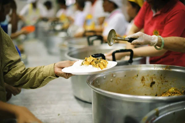 volunteers give food to local poor people, the villagers gladly accept the food as it may be the only food they get in a long while.