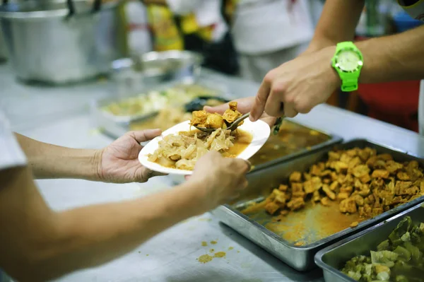 Free food distribution is social activity for helping the homeless people by giving them food.