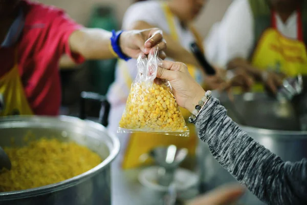 Volunteers are giving food to the homeless poor :  the concept of humane