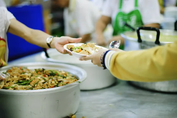 Feeding Food To Poor, Using leftovers to feed the hungry : concept serving free food to the poor