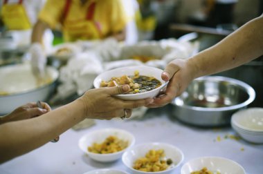 Açlığı hafifletmek için dilencilere yiyecek bağışı : toplumdaki diğer insanlar için yardım paylaşımı kavramı.
