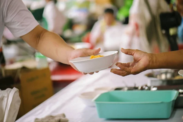 Volunteers Share Food to the Poor to Relieve Hunger: Charity concept