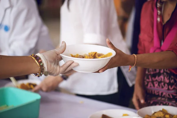 Sharing of food from volunteer hands to homeless people : The concept of feeding