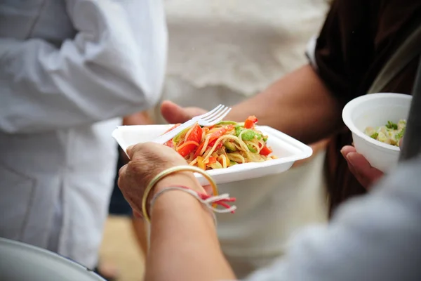 hand give food to hands of a beggar