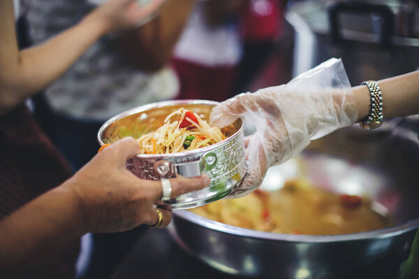 Volunteers give away free food to hungry people : concept of care And feeding