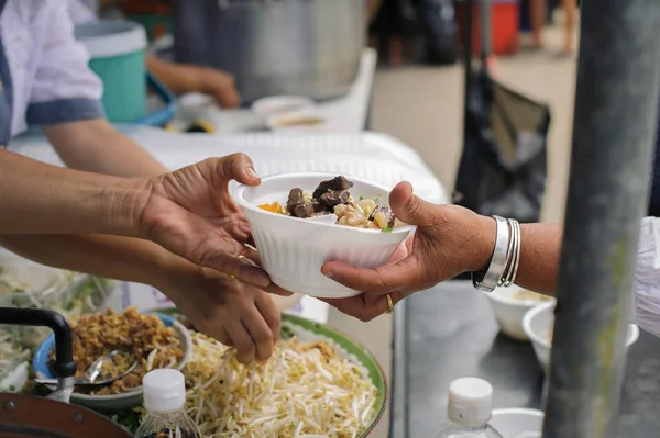Help serving free food to the poor Needy : concept Sharing Food With Homeless