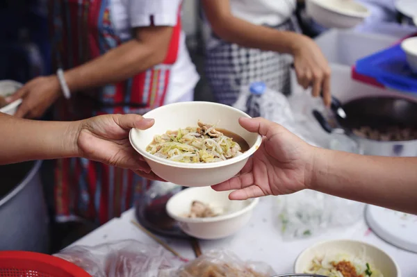 Help serving free food to the poor Needy : concept Sharing Food With Homeless