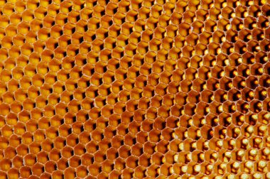 Balmumu bal peteğinin bir bölümünün arkaplan dokusu ve deseni makro görüntüde altın bal dolu bir arı kovanından