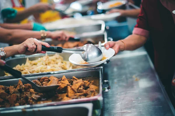 concept of free food serving : Volunteers serving food for poor people