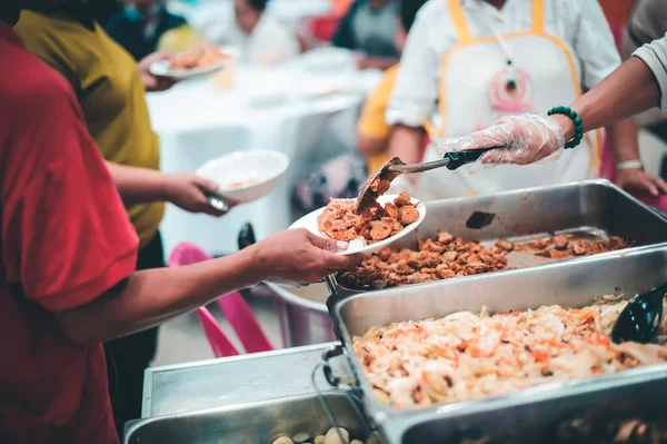 concept of free food serving : Volunteers serving food for poor people