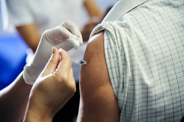 immunization vaccine injection , doctor inject vaccine to patient arm