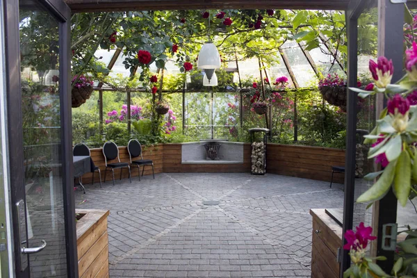 home built greenhouse covered in flowers