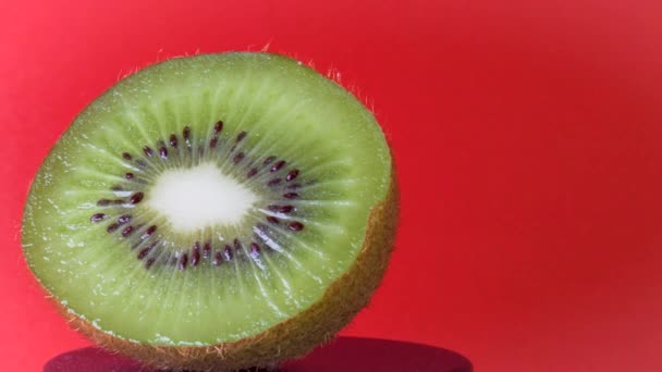Rotating Kiwi Close Up on a Red Background — Stock Video