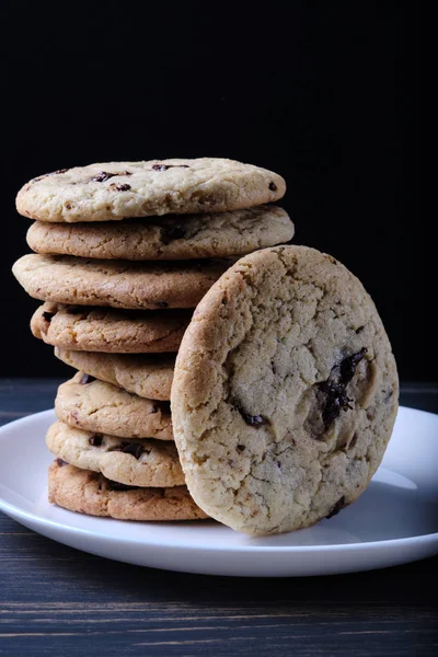 American chocolate chip cookies. Cookies, a glass of milk and a linen towel. Rustic still life.