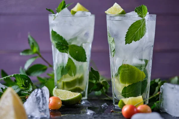 Mojito refreshing summer cocktail. Ingredients: ice, soda, rum, sugar syrup, lime, mint.
