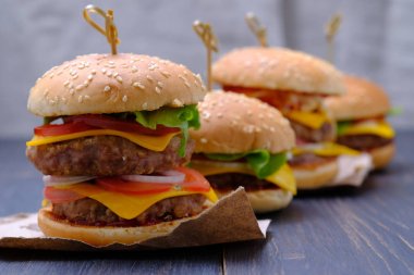 İki pirzola ile klasik Amerikan cheeseburgerleri. Farklı biber ve marul çeşitleri ile dekore edilmiş Cheeseburgerler. 