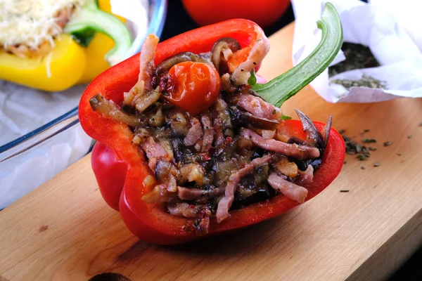 The process of cooking stuffed peppers. Pepper with eggplant, meat and tomato. Stuffed pepper