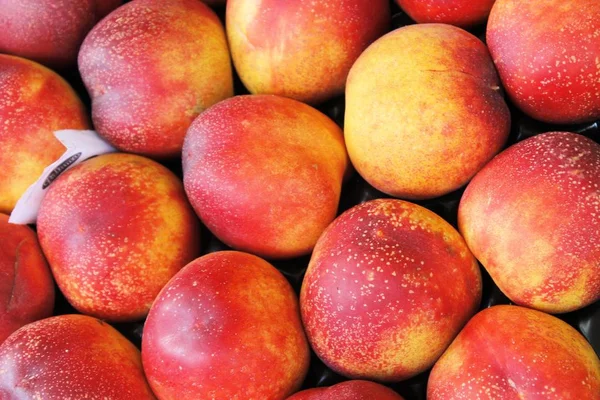 View close-up of fresh peaches. Juicy peaches. A lot of peaches.