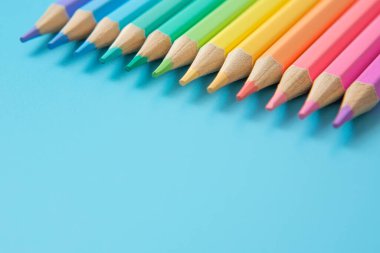 Mavi arkaplanda Pastel renkli kalemlerin renkli deseni ve boşluğu kopyala