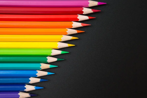 Pattern of Colorful Many colored pencils on a black background and copy space