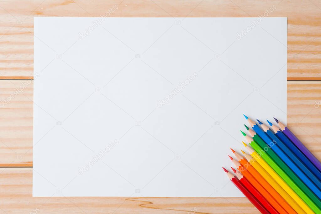 Pattern of Colorful Many colored pencils and white paper on wooden background and copy space